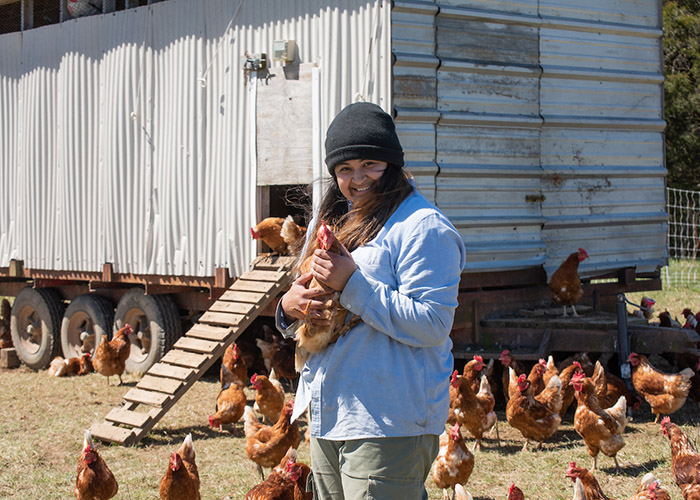 Farm student holding a chicken