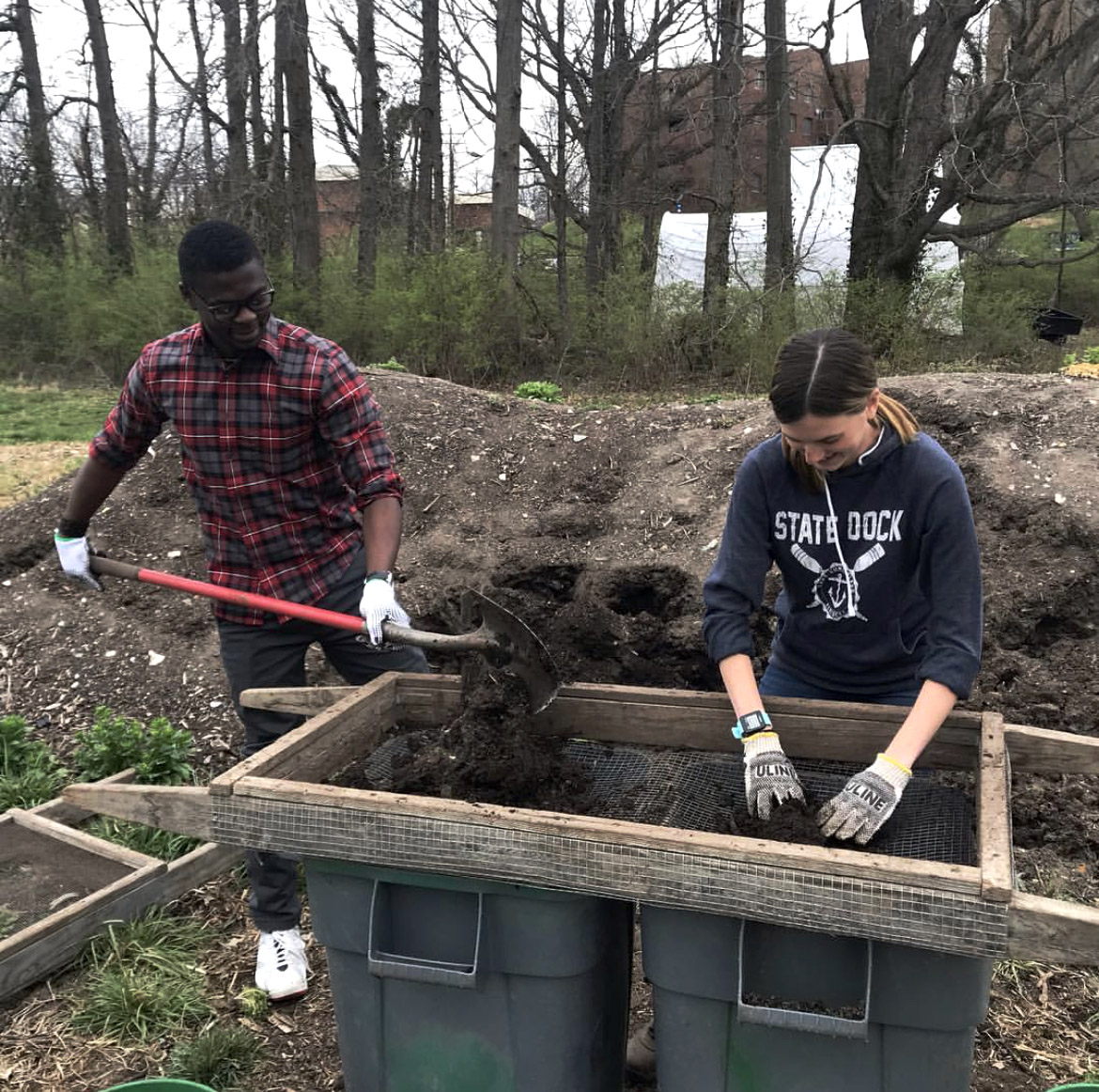 Students shoveling and sifting compost