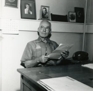Robert Spence sitting at his desk